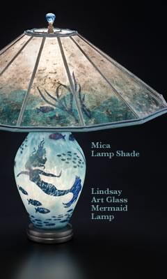 Lighted lamp base in this Lindsay Art Glass Mermaid Table Lamp + Mica lamp shade with tropical fish and seaweed