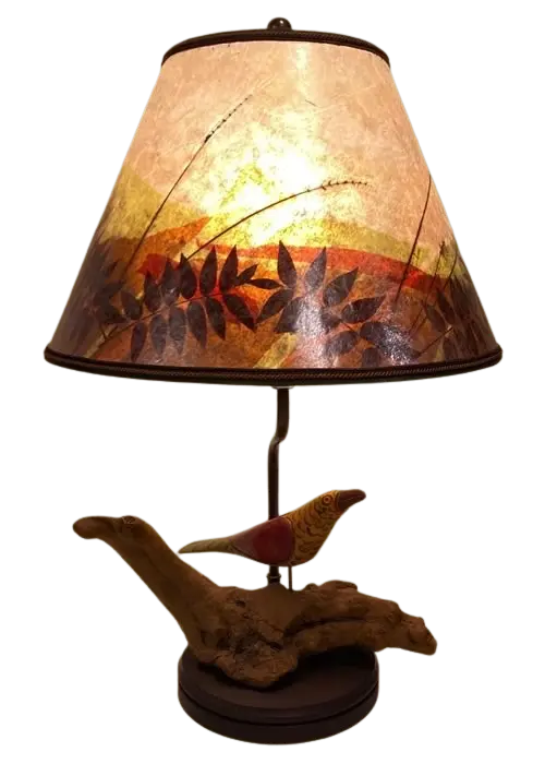 Antique hand-carved wooden "Fabulous Bird" lamp on a natural desert wood burl