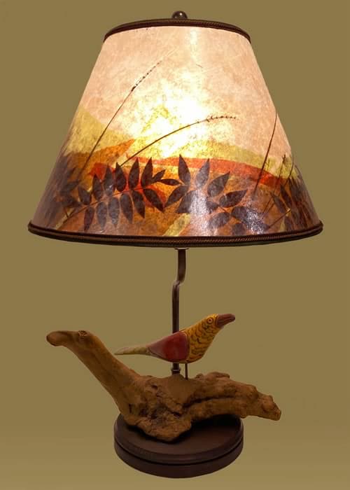 Antique hand-carved wooden "Fabulous Bird" lamp on a natural desert wood burl
